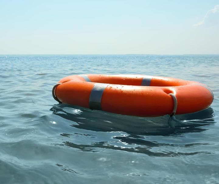 Orange life buoy floating in sea representing a rescued website.