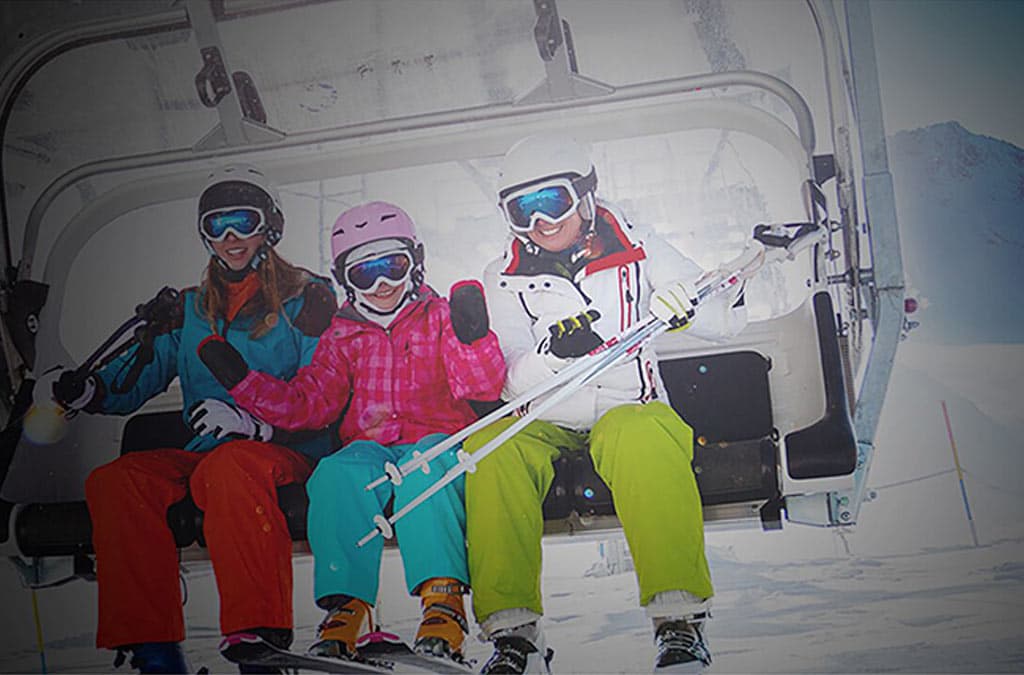 Family riding a chairlift at a ski resort