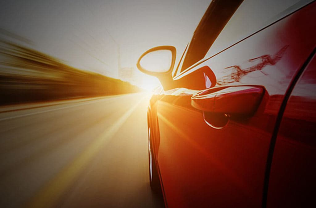 Volkswagen car driving into the sunset