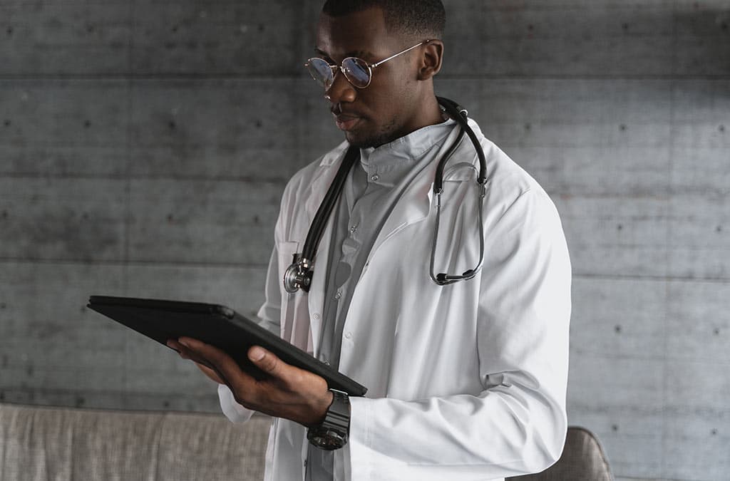 Doctor studying a tablet