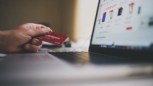 Photo of person using their credit card an an e-commerce website