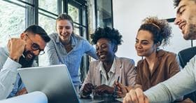 Diverse team looking at a laptop screen