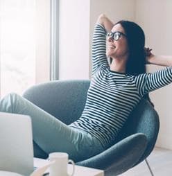 Woman relaxing because she's using Oshyn's Sitecore DevOps service
