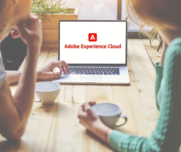 Women viewing Adobe Experience Cloud on a laptop